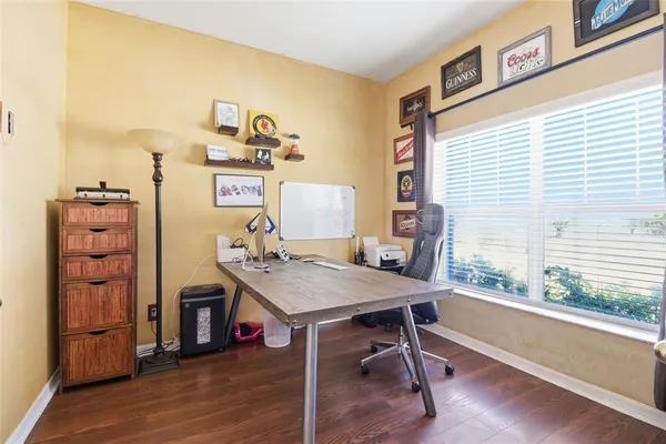 a view of a workspace with furniture and a window
