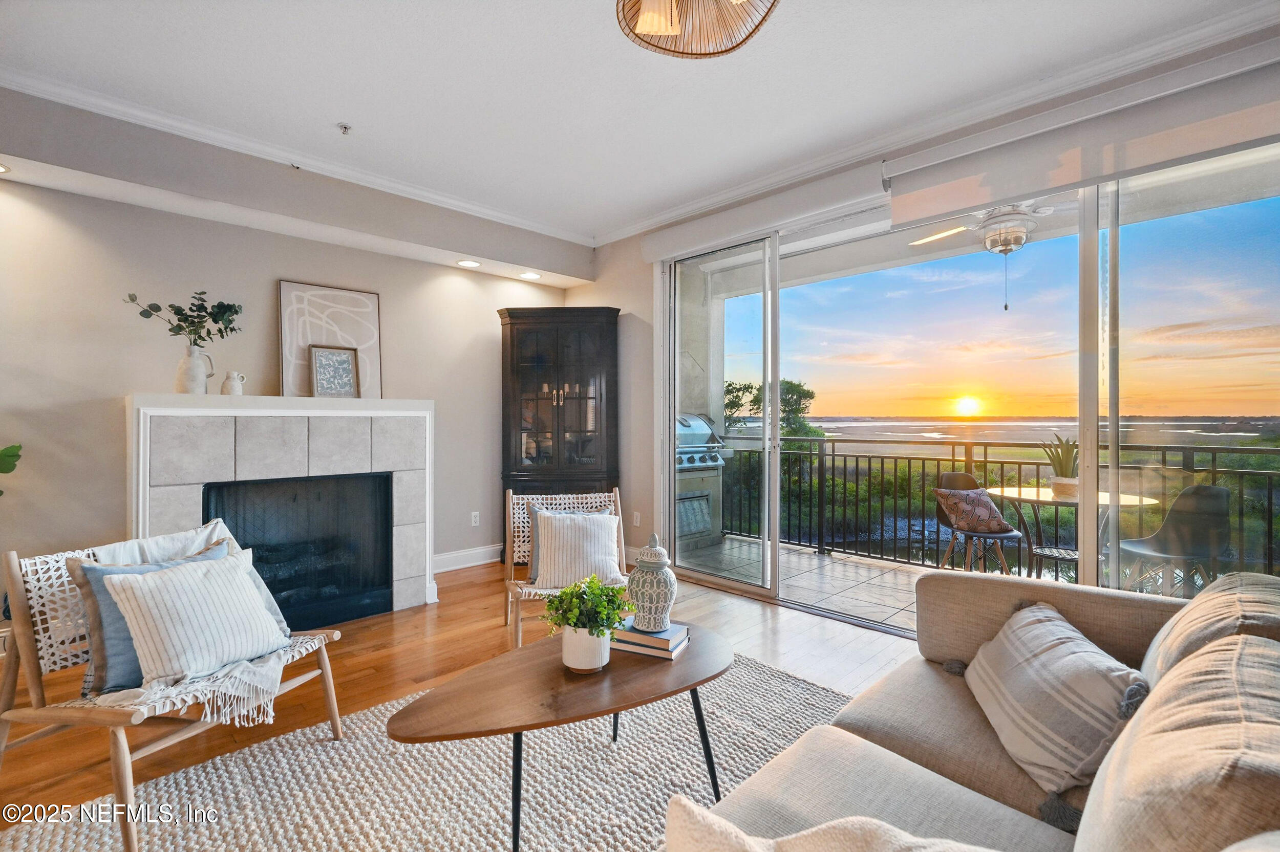 2102 Windjammer Lane St. Augustine, FL 32084 - Photo 11 of 47 a living room with furniture a floor to ceiling window and a fireplace