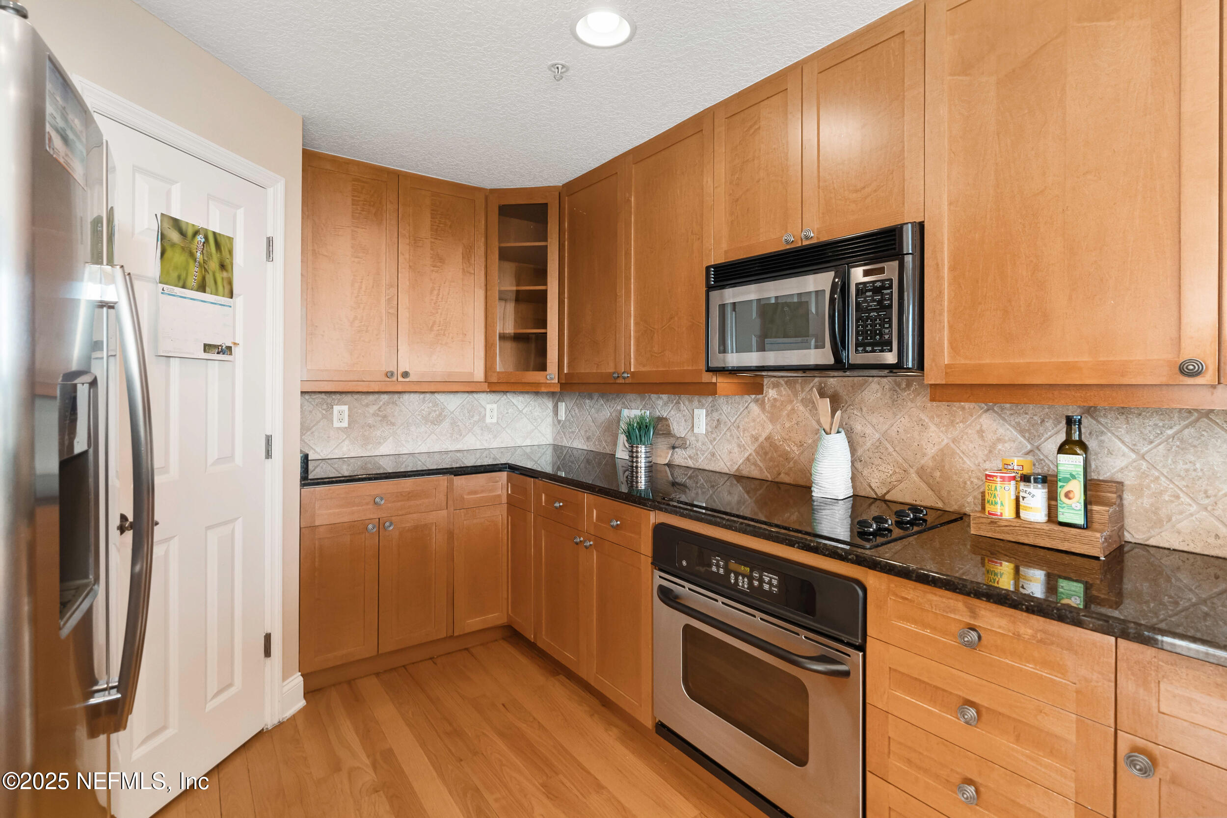 2102 Windjammer Lane St. Augustine, FL 32084 - Photo 17 of 47 a kitchen with granite countertop stainless steel appliances and wooden cabinets