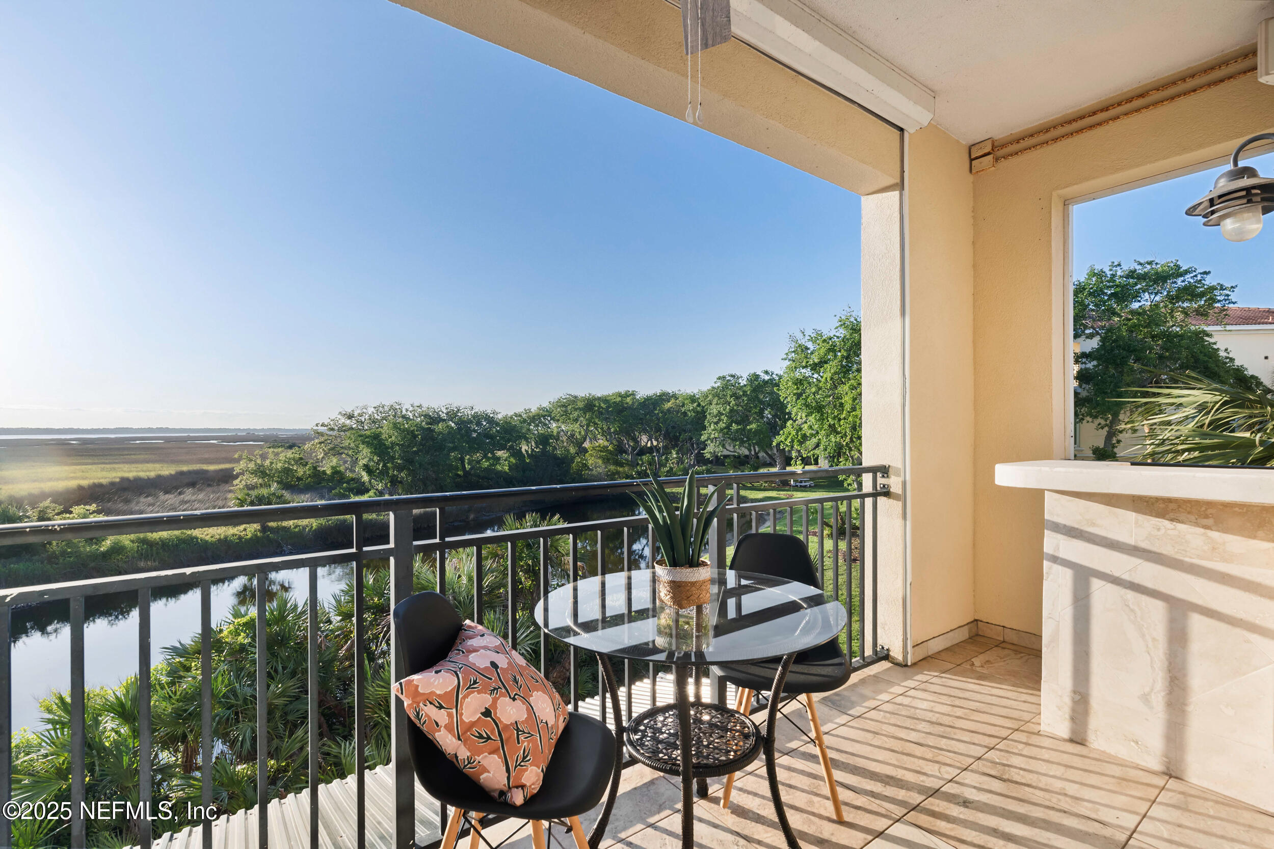 2102 Windjammer Lane St. Augustine, FL 32084 - Photo 21 of 47 a balcony with wooden floor table and chairs