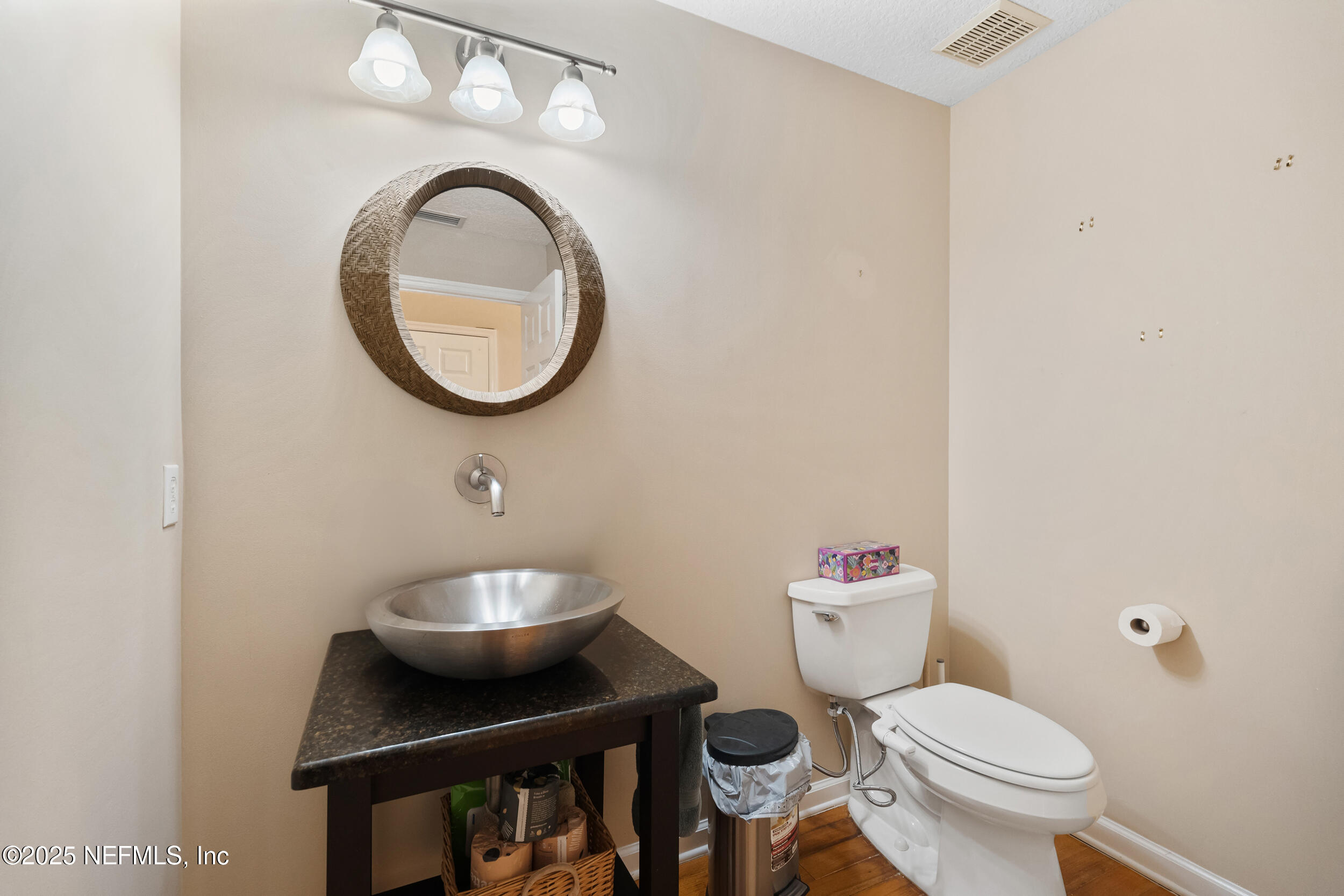2102 Windjammer Lane St. Augustine, FL 32084 - Photo 25 of 47 a bathroom with a toilet a sink and a mirror