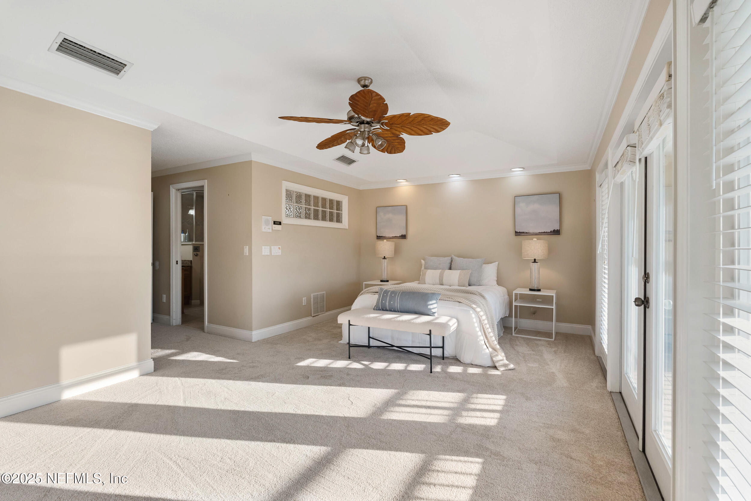 2102 Windjammer Lane St. Augustine, FL 32084 - Photo 27 of 47 a bedroom with a bed and a chandelier