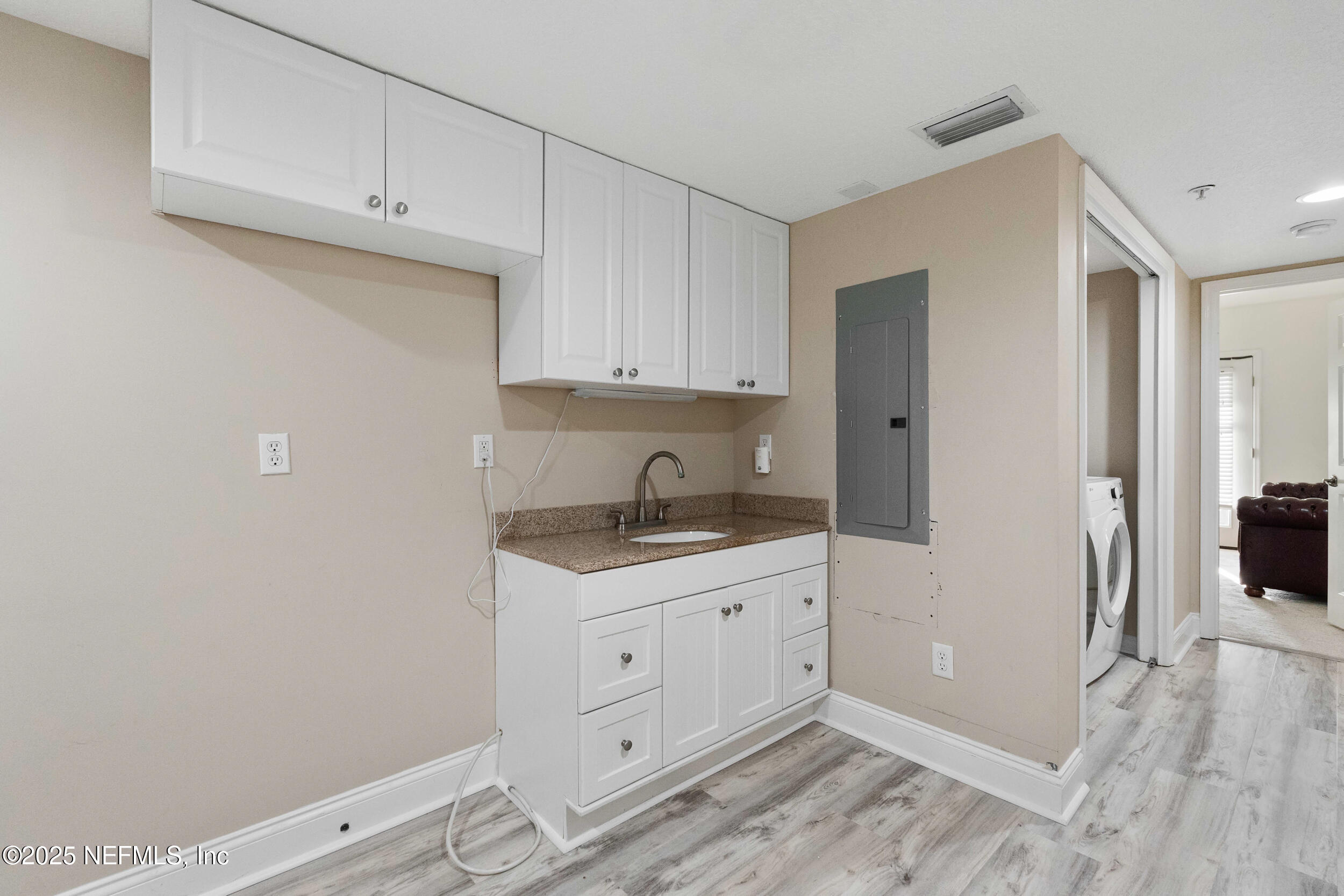 2102 Windjammer Lane St. Augustine, FL 32084 - Photo 37 of 47 a kitchen with a sink and cabinets