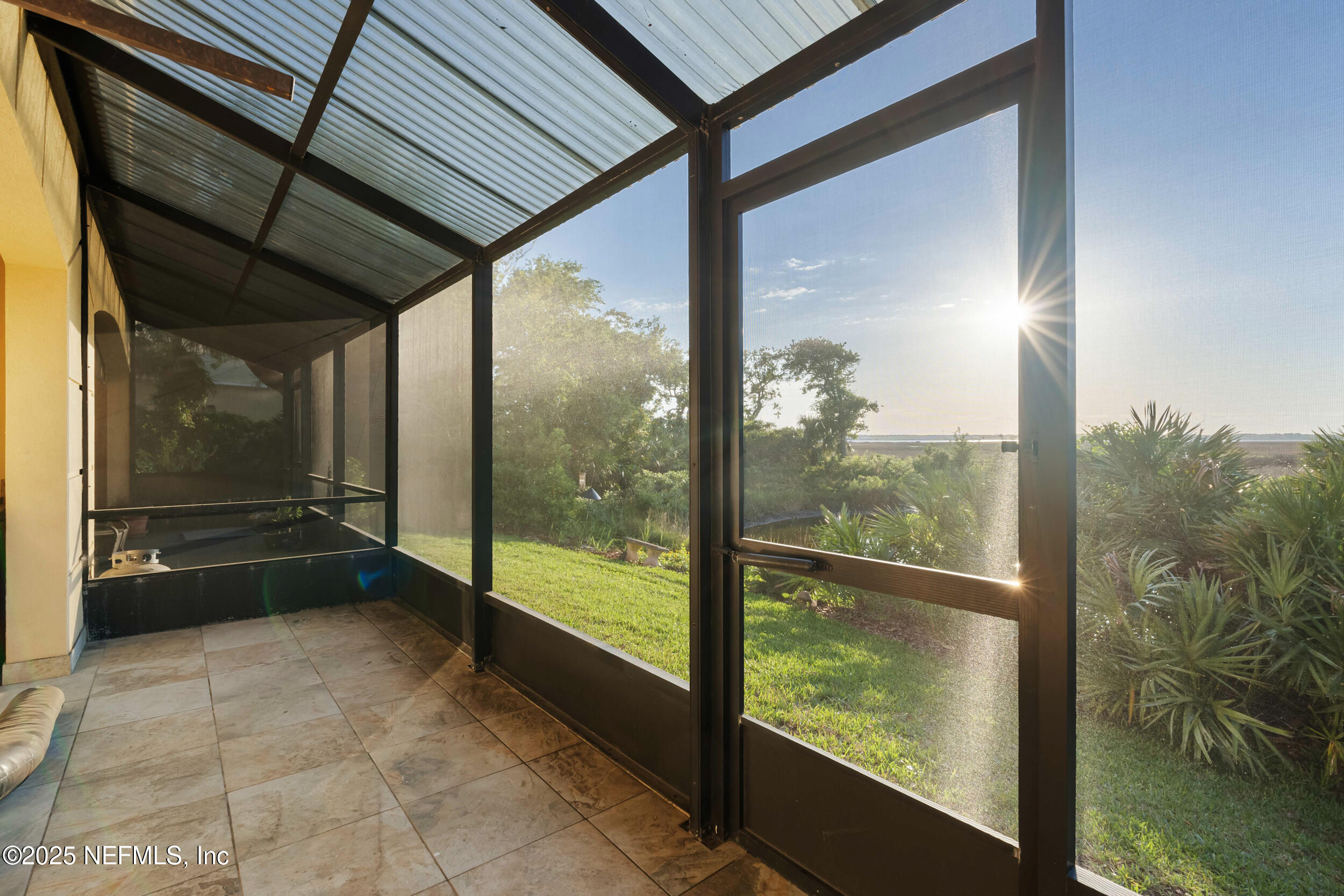 2102 Windjammer Lane St. Augustine, FL 32084 - Photo 42 of 47 a view of a glass door with a floor to ceiling window next to a yard