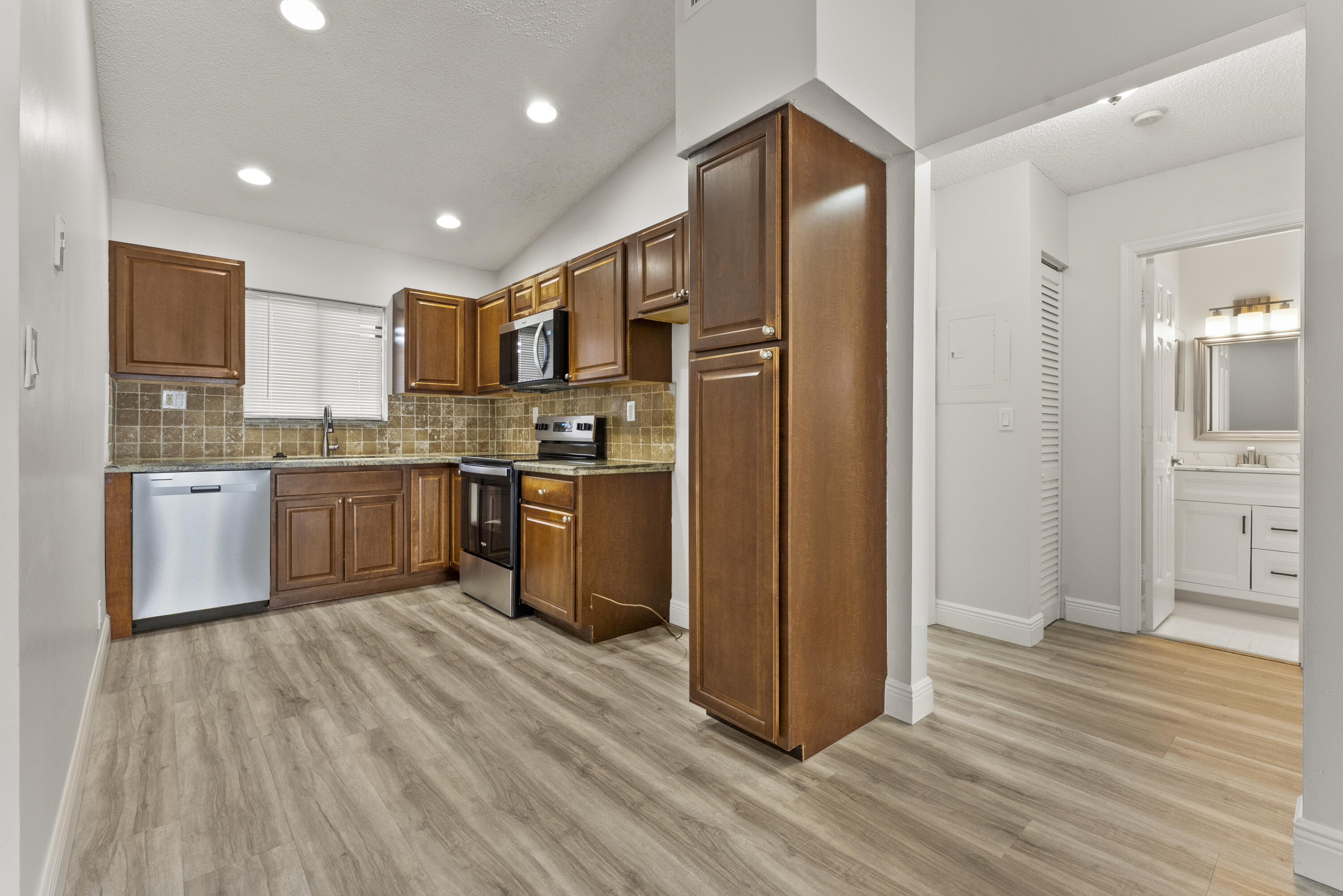 2900 Olivewood Terrace, Unit 2010 Boca Raton, FL 33431 - Photo 3 of 22 a kitchen with stainless steel appliances granite countertop a refrigerator and a stove top oven