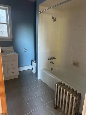 a bathroom with a bathtub sink and toilet