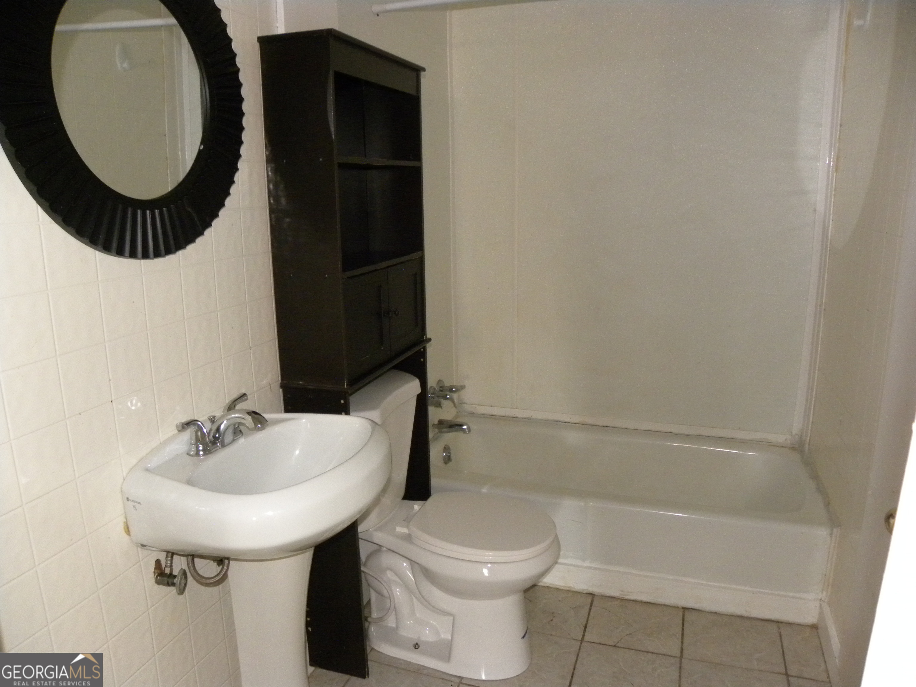 225 South Webb Street Hartwell, GA 30643 - Photo 12 of 24 a bathroom with a sink and a mirror