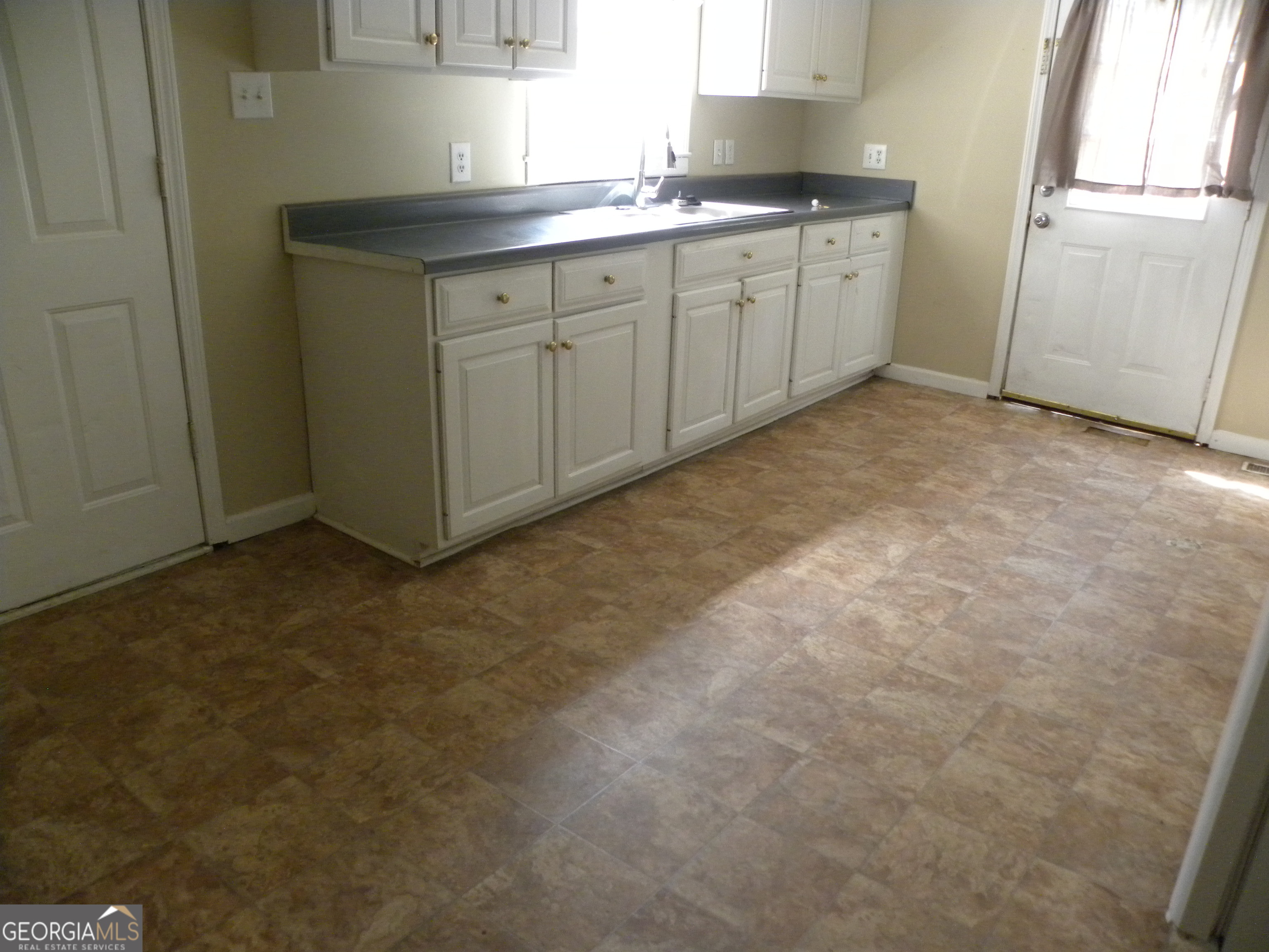 225 South Webb Street Hartwell, GA 30643 - Photo 14 of 24 a kitchen with a sink and cabinets