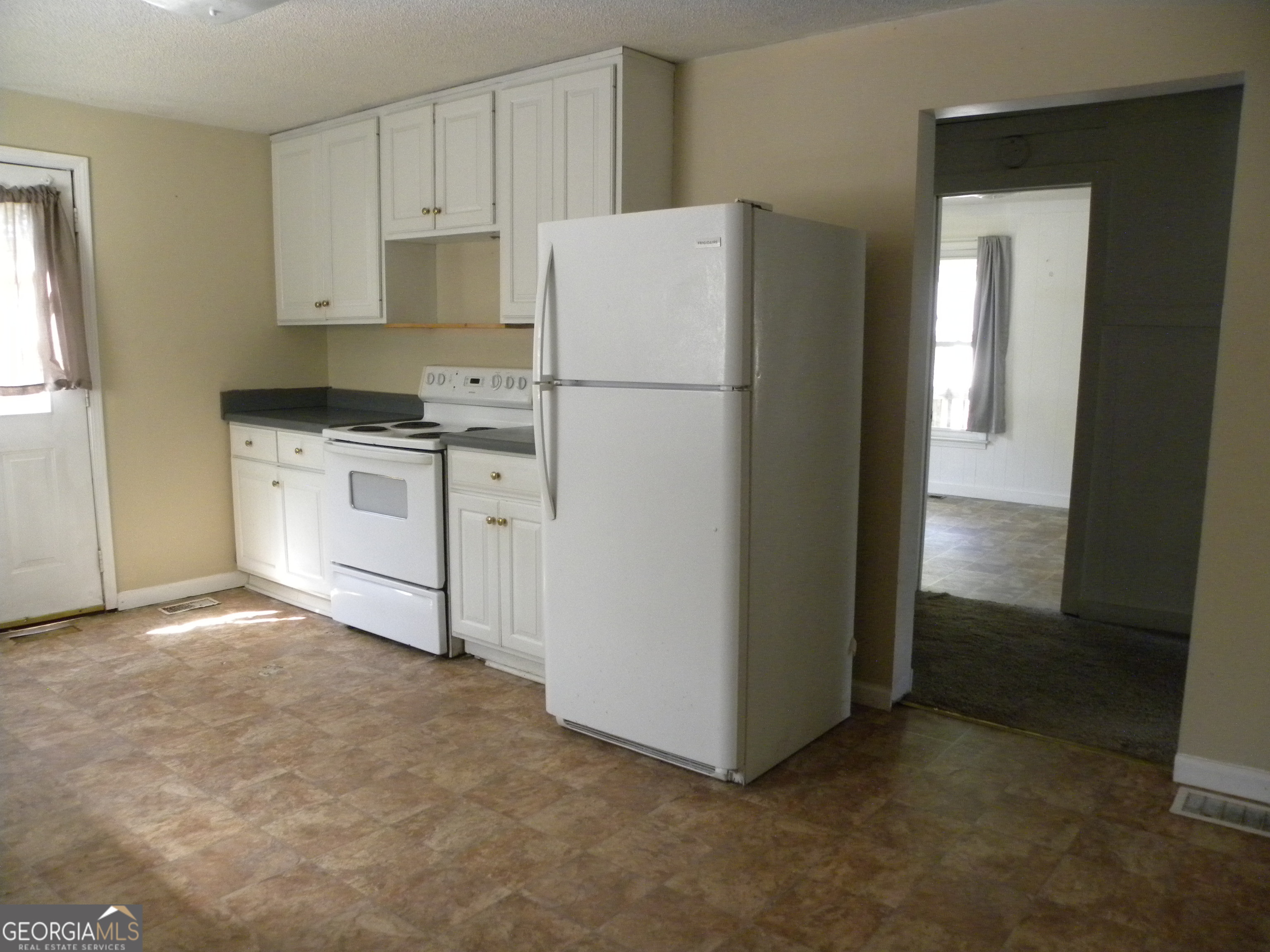 225 South Webb Street Hartwell, GA 30643 - Photo 16 of 24 a kitchen with cabinets and white stainless steel appliances