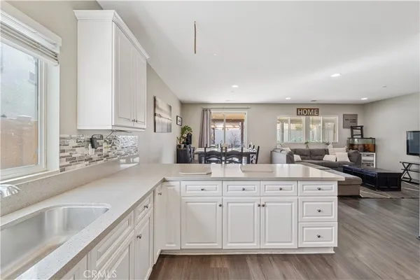 a kitchen with a sink cabinets and window