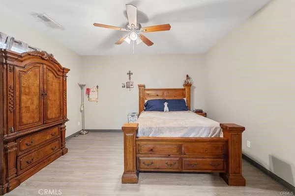 a bedroom with a bed and a tv on the dresser