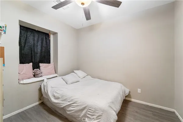 a bedroom with a bed and a mirror