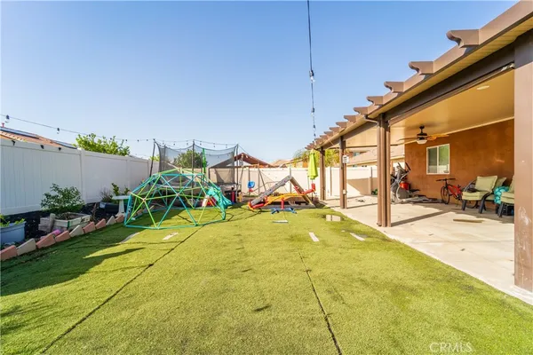 a swimming pool with yard and outdoor seating
