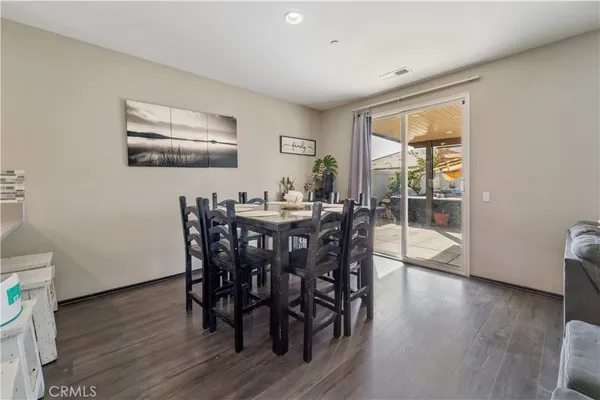 a dining room with furniture and wooden floor