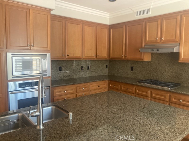 61 Autumn Irvine, CA 92602 - Photo 14 of 14 a kitchen with stainless steel appliances granite countertop a sink and cabinets