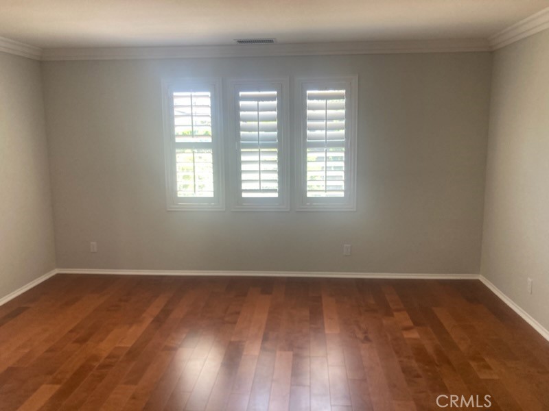61 Autumn Irvine, CA 92602 - Photo 2 of 14 an empty room with wooden floor and windows