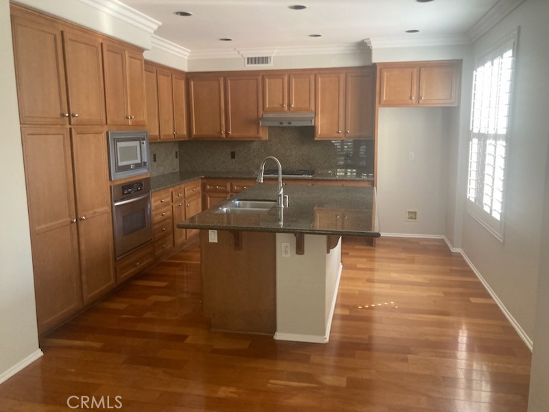 61 Autumn Irvine, CA 92602 - Photo 7 of 14 a kitchen with stainless steel appliances granite countertop a refrigerator sink and cabinets