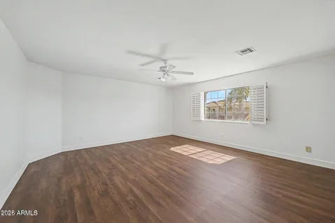 a view of a livingroom with wooden floor and entryway