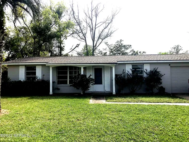 a view of a house with a yard and a large window