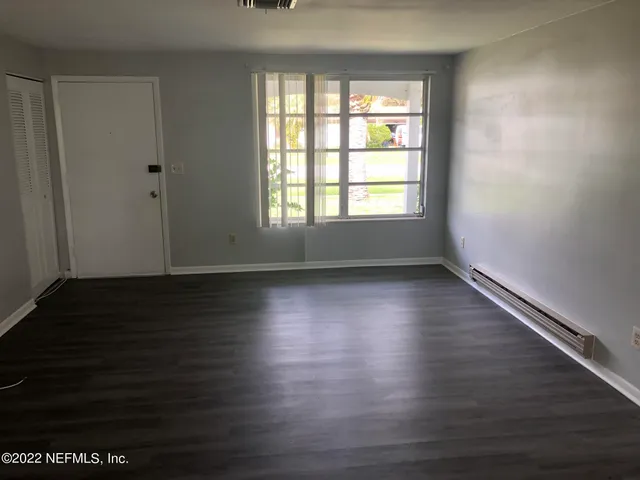 wooden floor in an empty room with a window