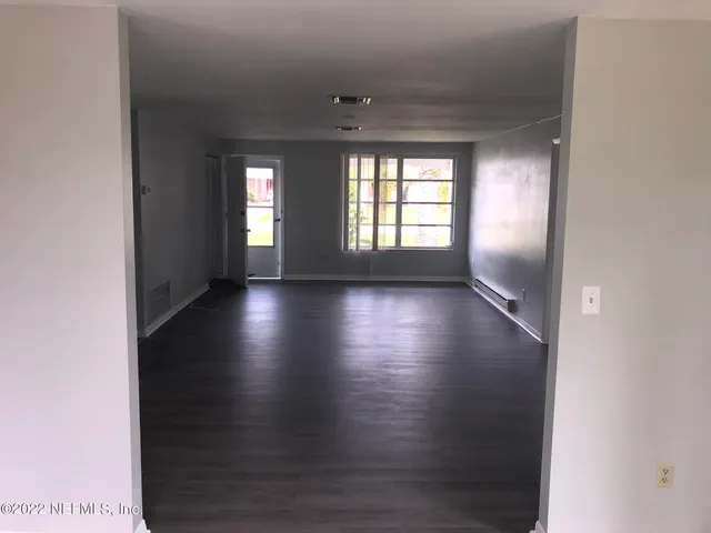 a view of room with window and hardwood floor