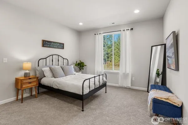 a spacious bedroom with a bed and a desk