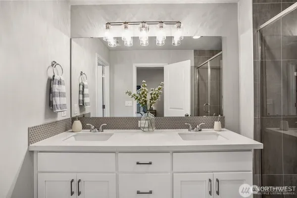 a bathroom with a shower sink and mirror