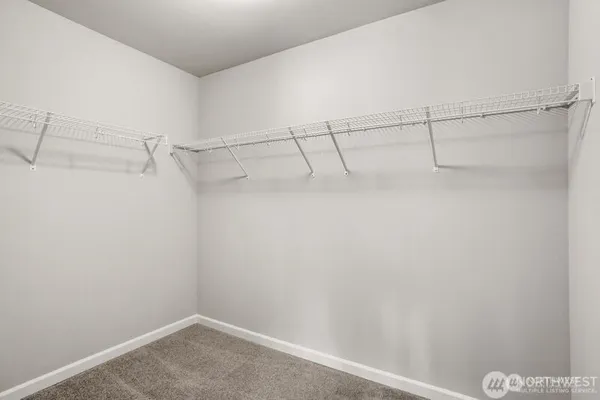 a living room with furniture a window and a potted plant