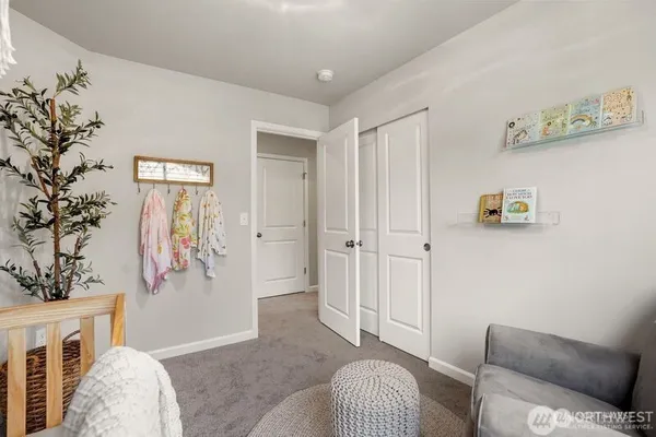 a bed room with a bed and a chair