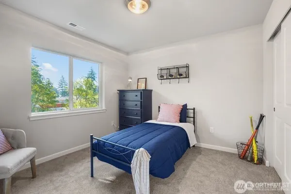 a bathroom with a granite countertop sink mirror vanity and toilet
