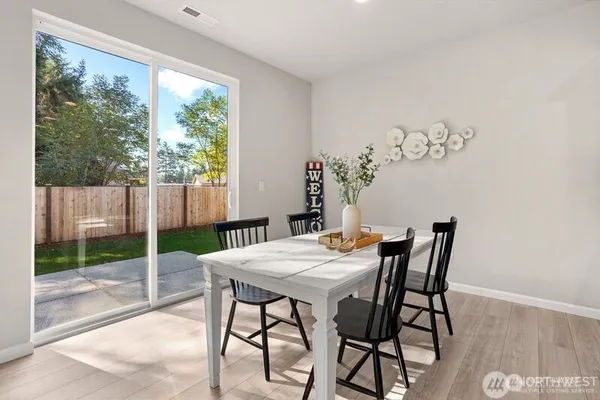 a view of a dining room with furniture window and wooden floor