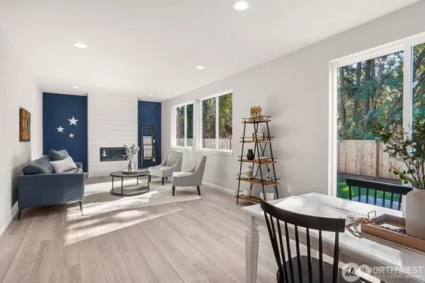 a living room with furniture a window and wooden floor
