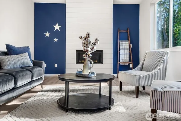 a living room with furniture a lamp and a potted plant