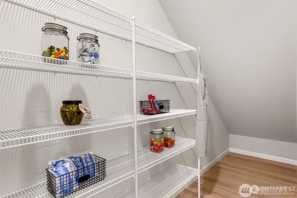 a bedroom with furniture and a wooden floor