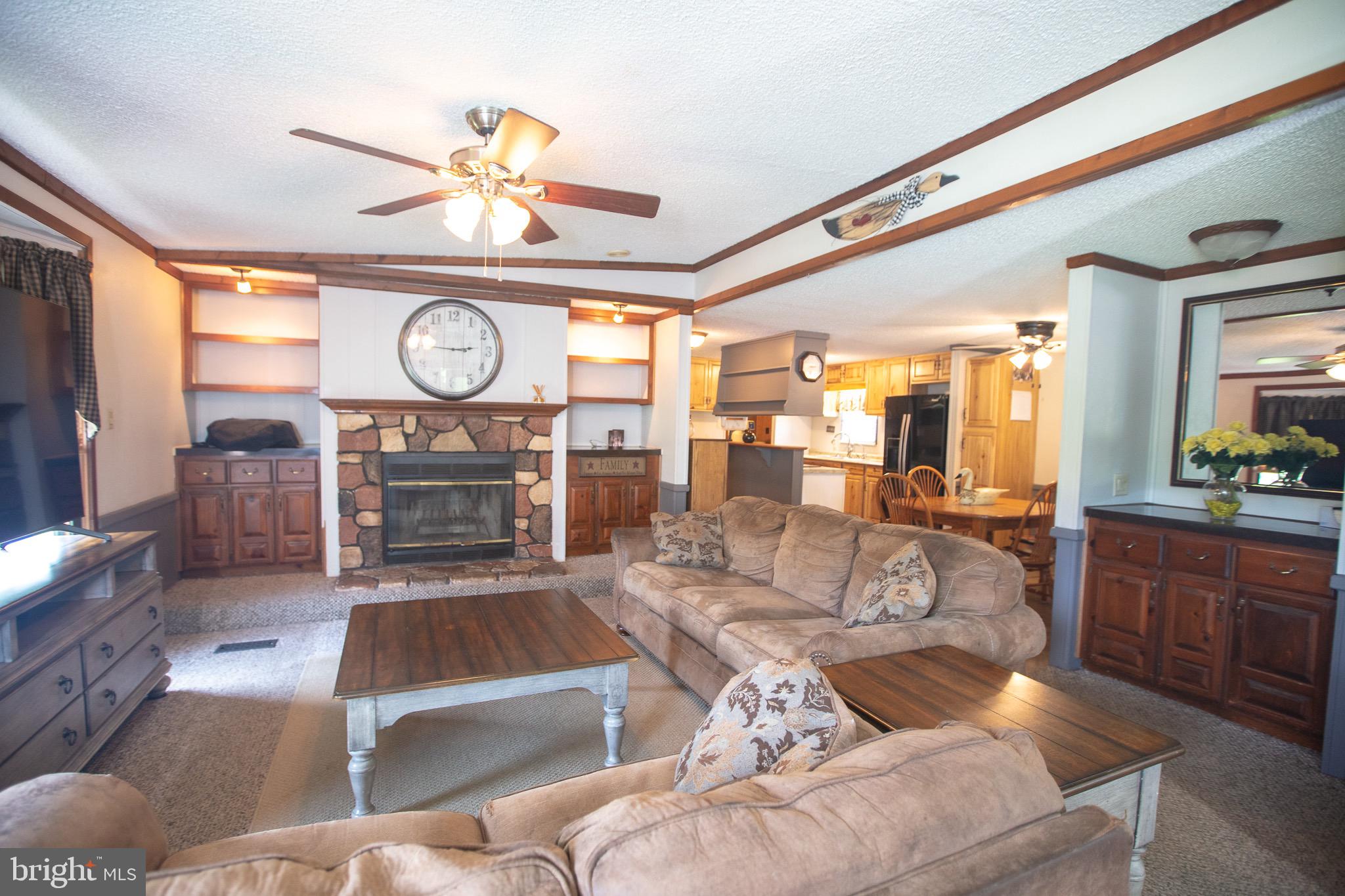 2555 Fords Corner Road Hartly, DE 19953 - Photo 12 of 43 a living room with furniture a clock and a fireplace