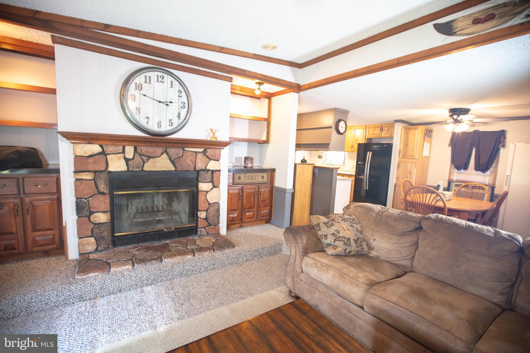 2555 Fords Corner Road Hartly, DE 19953 - Photo 14 of 43 a living room with furniture a clock and a fireplace