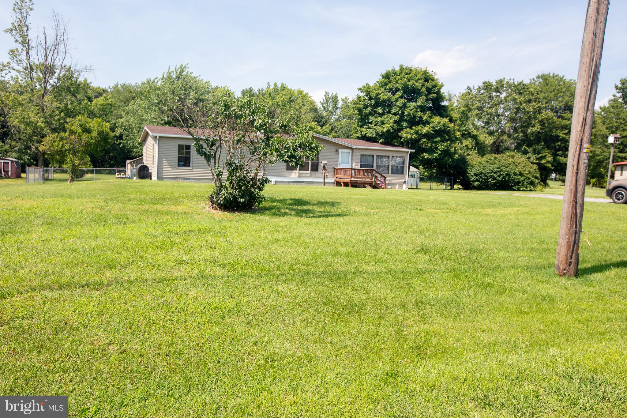 2555 Fords Corner Road Hartly, DE 19953 - Photo 2 of 43 a front view of a house with a garden