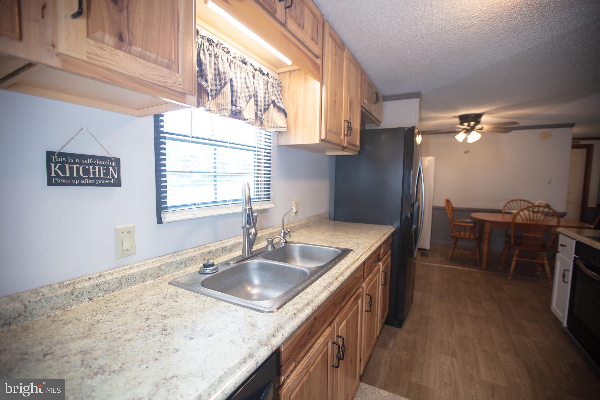2555 Fords Corner Road Hartly, DE 19953 - Photo 22 of 43 a kitchen with sink cabinets and window