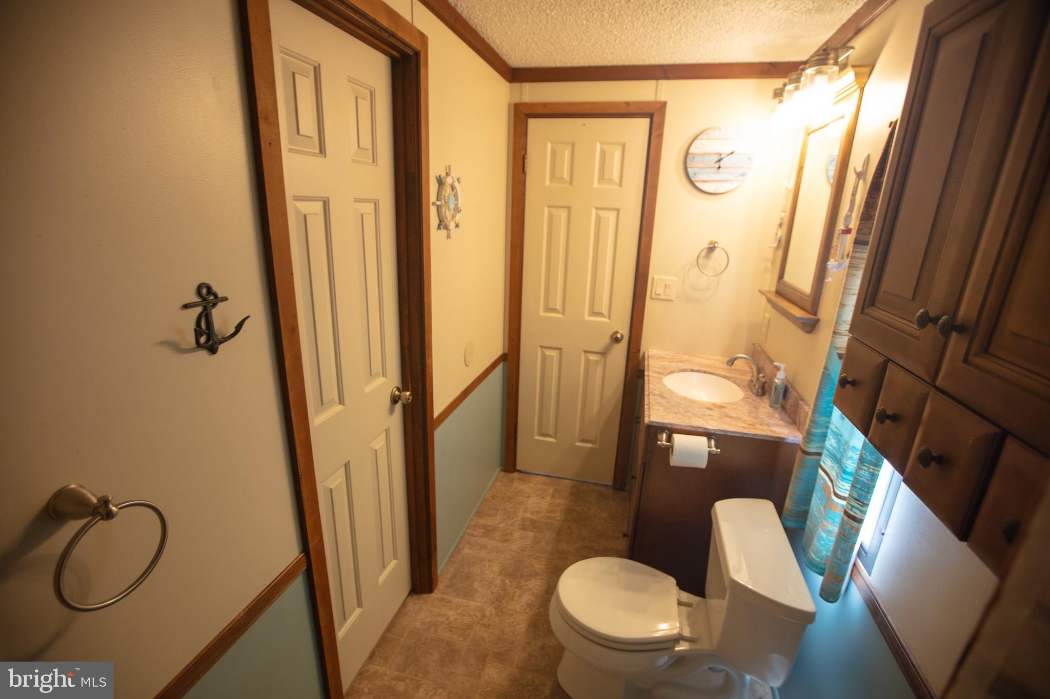 2555 Fords Corner Road Hartly, DE 19953 - Photo 30 of 43 a bathroom with a granite countertop sink toilet and shower