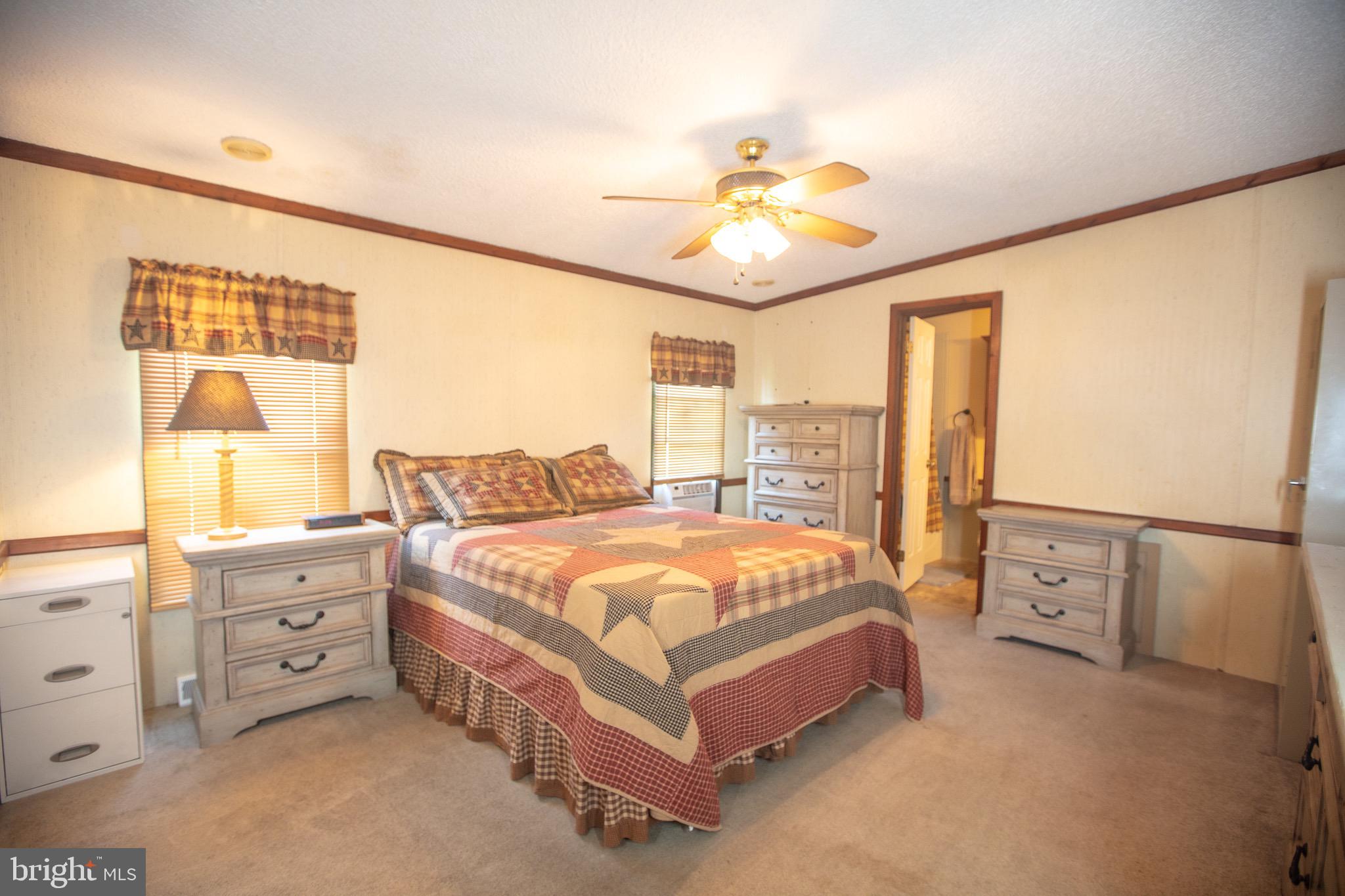 2555 Fords Corner Road Hartly, DE 19953 - Photo 31 of 43 a spacious bedroom with a bed and a chandelier