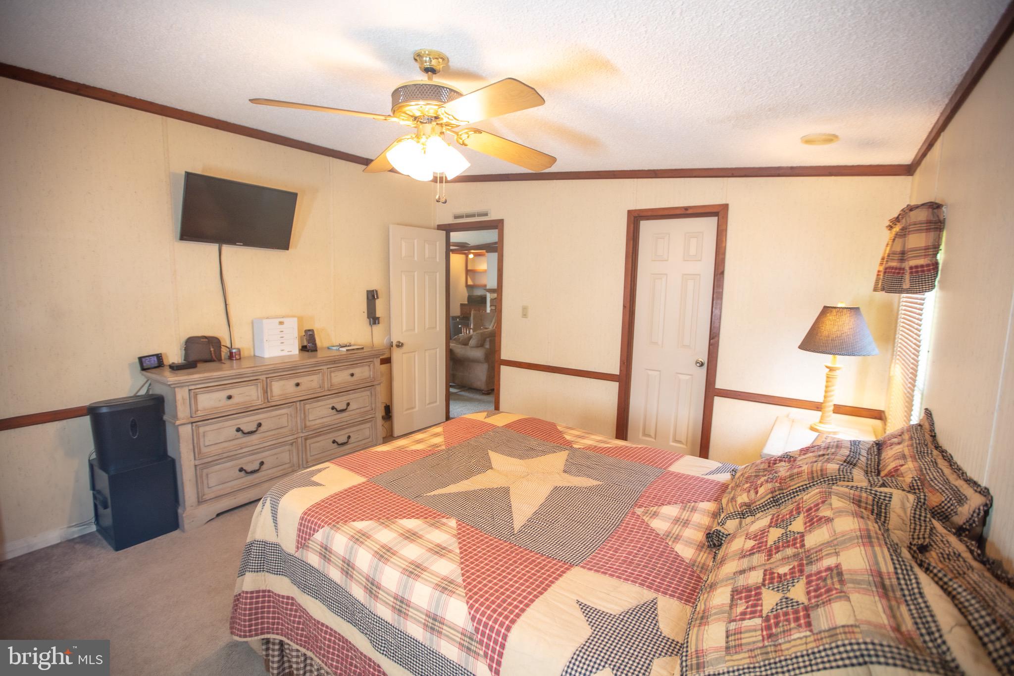 2555 Fords Corner Road Hartly, DE 19953 - Photo 32 of 43 a bedroom with a bed and a chandelier