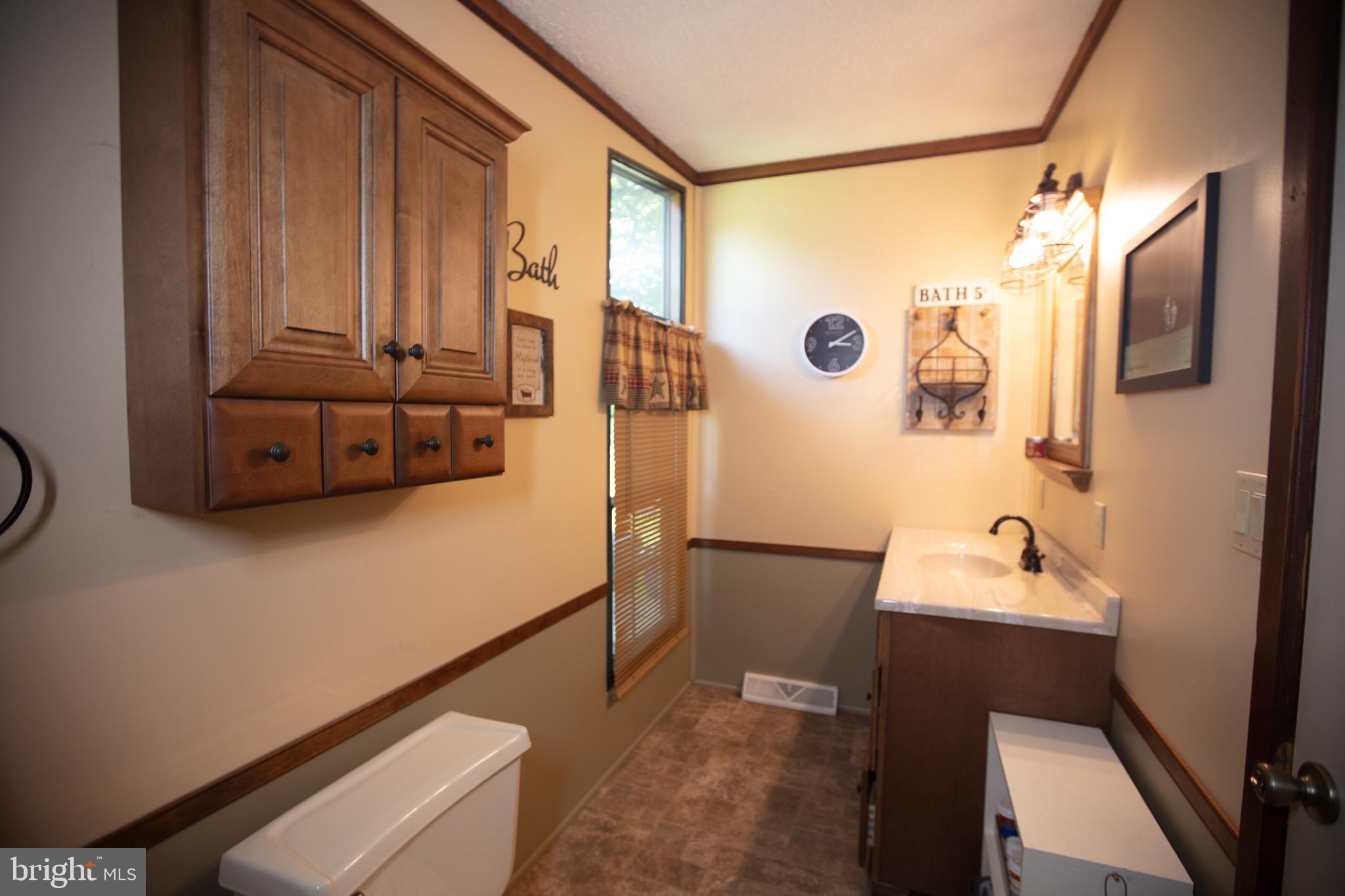 2555 Fords Corner Road Hartly, DE 19953 - Photo 34 of 43 a bathroom with a sink and a mirror