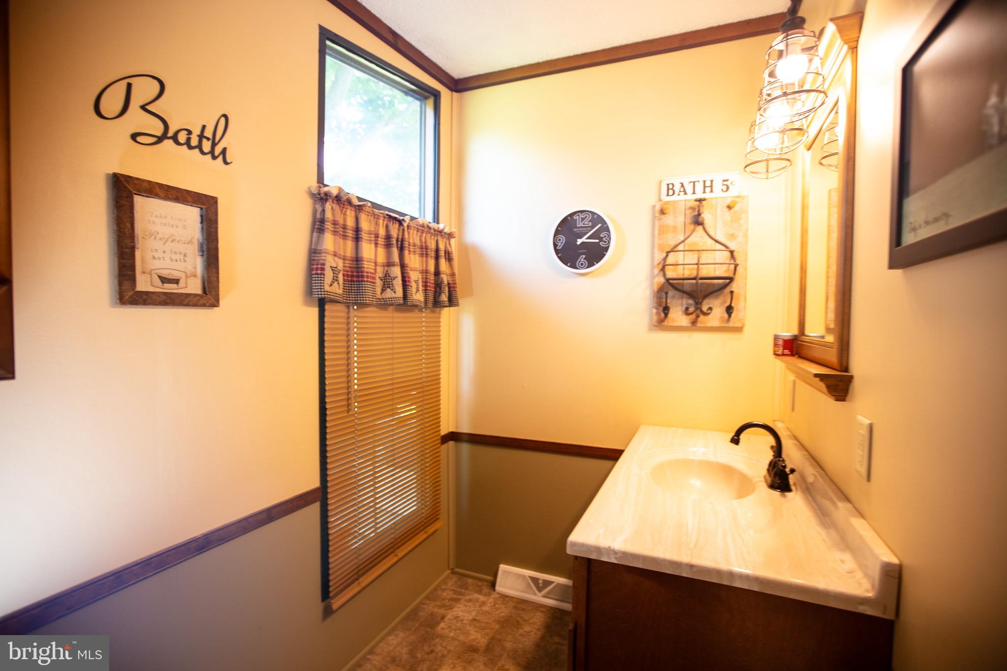2555 Fords Corner Road Hartly, DE 19953 - Photo 35 of 43 a bathroom with a sink and a mirror