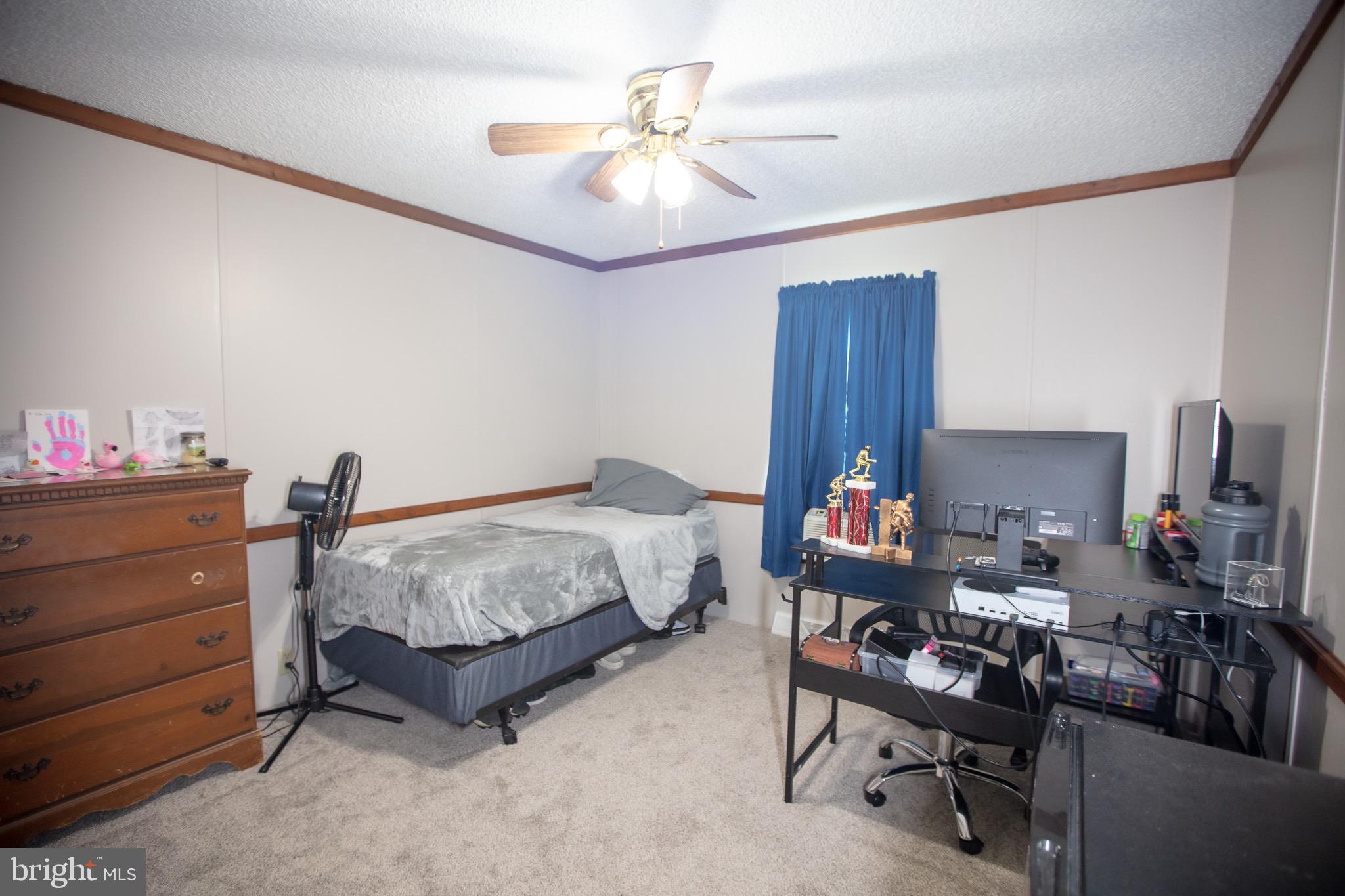 2555 Fords Corner Road Hartly, DE 19953 - Photo 38 of 43 a bed room with a bed and a chandelier