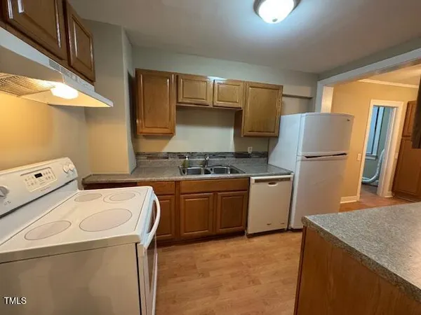 a kitchen with a sink a stove and refrigerator