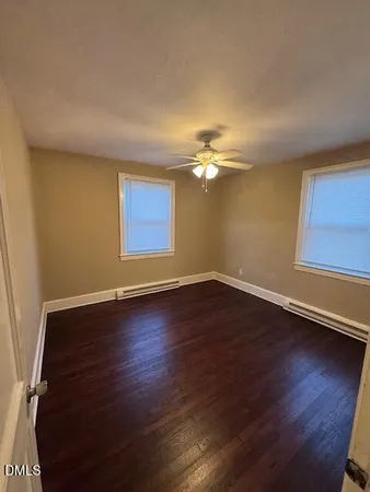 a view of a livingroom with wooden floor and window