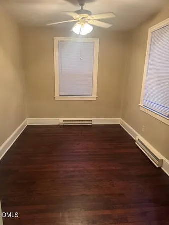 a view of a room with wooden floor and window