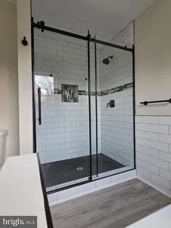 a bathroom with a shower and a glass door
