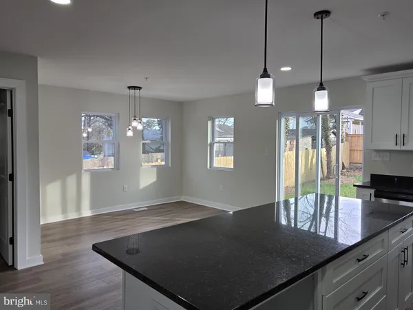a open kitchen with kitchen island a counter space a sink and appliances