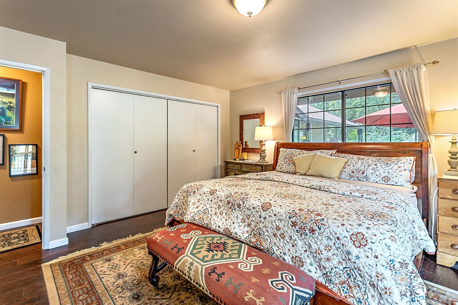 9155 North Applegate Road Grants Pass, OR 97527 - Photo 22 of 35 a bedroom with a bed and wooden floor